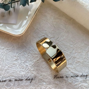 Minimalist wide gold-plated stainless steel cuff bracelet with high-polish mirror finish