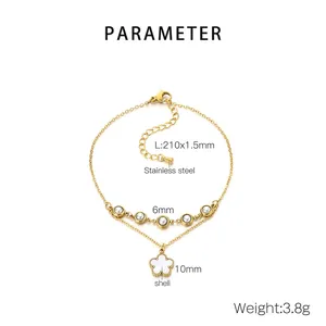 Detail view of a double-layered gold stainless steel anklet with shell flower and pearls