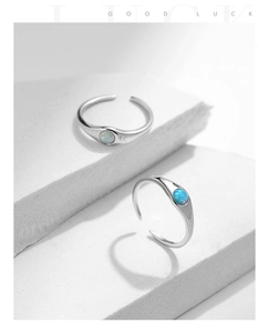 Macro detail of adjustable S925 silver ring featuring a round opal stone on white stones