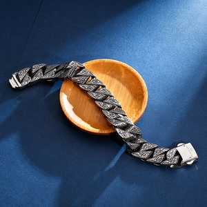 Macro detail of retro 316L stainless steel bracelet with engraved floral pattern