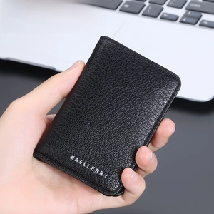 Slim black lychee pattern leather wallet for men held by hand in business setting