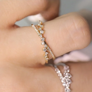 Macro shot of 925 sterling silver double-layer wave ring with micro-paved diamonds