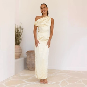 Detail of elegant pale yellow satin one-shoulder dress with soft draped neckline and texture