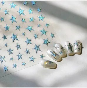 Macro shot of silver laser star nail stickers with 3D holographic effect on white nails