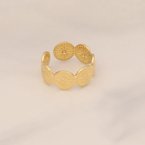 Detailed close-up of golden stainless steel ring featuring embossed sunflower patterns