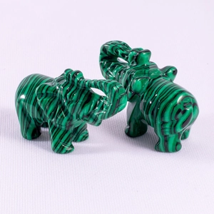 Detail view of 1.5 inch malachite elephant figurines with unique black stripe patterns