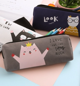 Detail view of canvas pencil cases featuring cute cat prints and secure black zippers