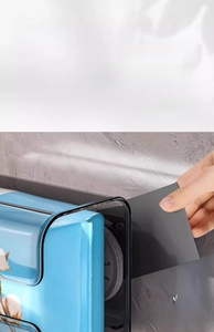 Close-up showing the removal of suction cup mount from blue wall tissue box