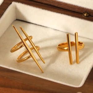 Detailed shot of two gold irregular geometric stainless steel rings on a jewelry box