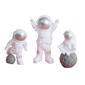 Three-piece white astronaut cake toppers set with silver details for outer space parties
