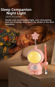 Pink astronaut desk lamp with pencil sharpener and star detail for kids' bedrooms