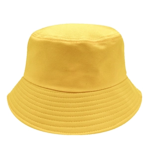 Detailed close-up of a vibrant yellow cotton bucket hat with reinforced stitched brim