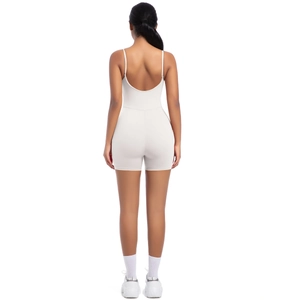 Detailed back view of a light gray backless yoga bodysuit with thin straps and shorts