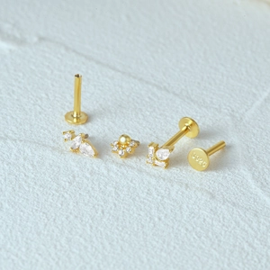 Detail of three gold 925 sterling silver labret studs with zircon and S925 hallmark