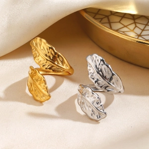 Exaggerated feather rings in gold and silver stainless steel with detailed textures