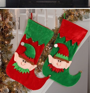 Detail of hanging Christmas elf candy bags with bells on a festive staircase railing