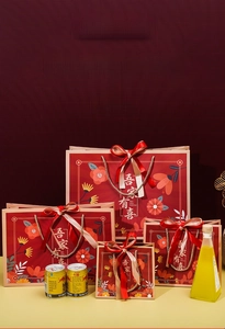 Detailed set of four red wedding gift bags with floral patterns and gold handles