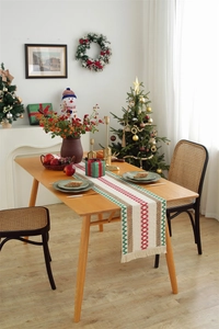 Detail of Christmas table runner featuring woven cotton linen fabric and tassel edges