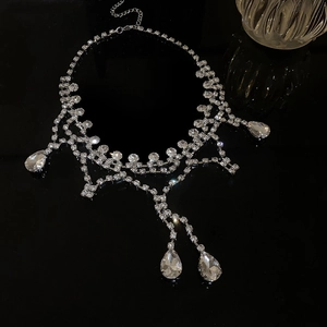 Macro shot of silver-colored layered tassel necklace with sparkling rhinestone pendants