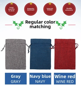 Detail of gray, navy, and wine red drawstring burlap sacks with woven linen texture