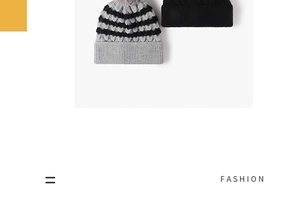 Close-up of striped beanie with grey faux fur pompom and black knit hat texture