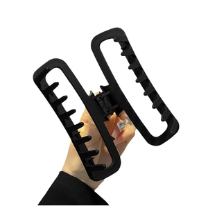 Matte brown rectangular claw clip for thick hair shown in a hand-held product view