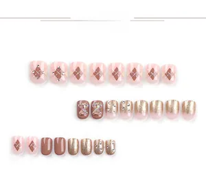 Macro detail of pre-set nails with 3D resin bear, plaid patterns, and rhinestone accents