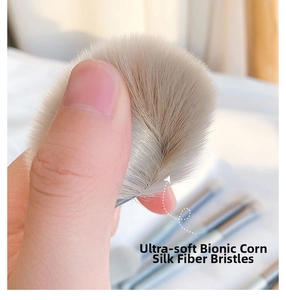 Close-up of ultra-soft bionic fiber bristles on a makeup brush being pressed by a finger