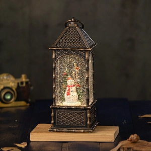 Vintage bronze Christmas lantern music box with snowman and swirling glitter snow