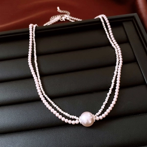 Detailed view of French vintage double-layer pearl and crystal necklace set with large pendant