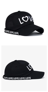 Detail of LOVE embroidery and ribbon trim on black cotton canvas baseball cap
