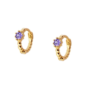 Detailed close-up of gold beaded hoop earrings featuring a small purple gemstone insert