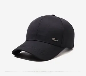 Detail of black twill baseball cap with silver metal Sport badge on the side profile