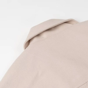 Close-up of the beige wool-blend coat collar with professional stitching detail
