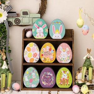 Colorful Easter rabbit egg-shaped tin boxes with festive cartoon patterns in a display