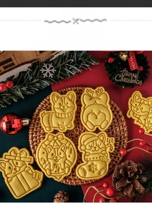 Macro view of Corgi Christmas cookie cutters and baked holiday biscuits in straw tray