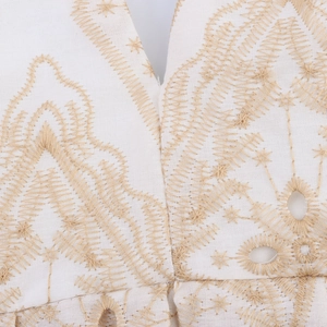 White vacation maxi dress with intricate gold embroidery and hollow-out detailing