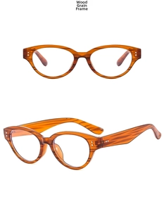 Detailed macro view of vintage cat-eye glasses featuring an amber wood grain texture frame
