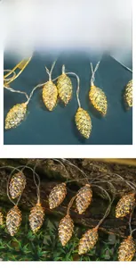 Macro detail of pinecone LED string lights with warm glowing metal scale texture