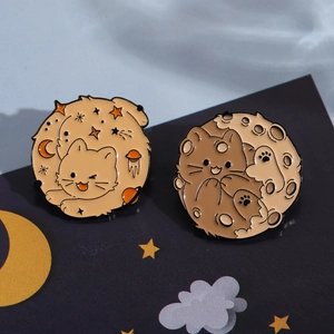 Cute space cat enamel pins featuring orange and brown cats on stars and moon