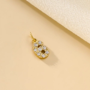 Close-up of gold-plated number 6 heart pendant with sparkling pavé zircon crystals