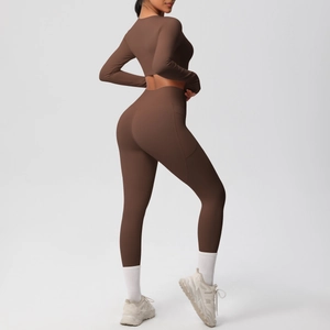 Detail of high-waist yoga pants in dark coffee with a functional side pocket for fitness