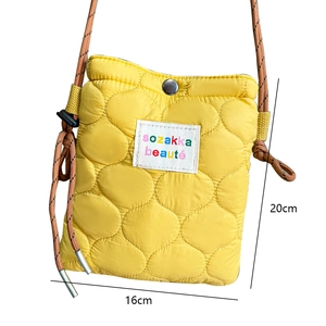 Quilted yellow puffy crossbody bag with dimensions 16cm by 20cm and brown strap