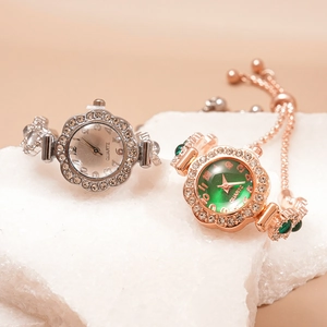 Elegant rhinestone quartz bracelet watch in silver and rose gold on a natural stone base