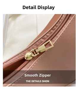 Close-up of golden metal zipper on dusty pink leather handbag with lychee texture