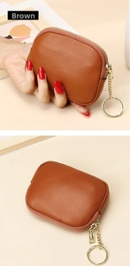 Macro detail of brown pebble leather coin purse with golden zipper and keychain