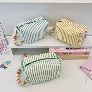 Striped seersucker fabric tissue organizer bag with colorful wooden beaded handle
