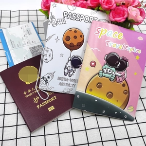 Detailed view of travel passport covers with space-themed designs and boarding pass props