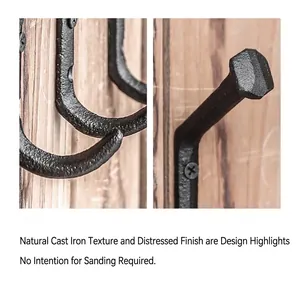 Close-up of industrial cast iron wall hook with natural speckled texture on wood base
