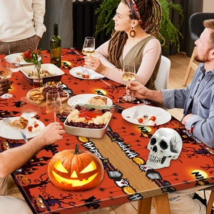 Halloween tablecloth featuring pumpkins, ghosts and castles in a festive dining scene